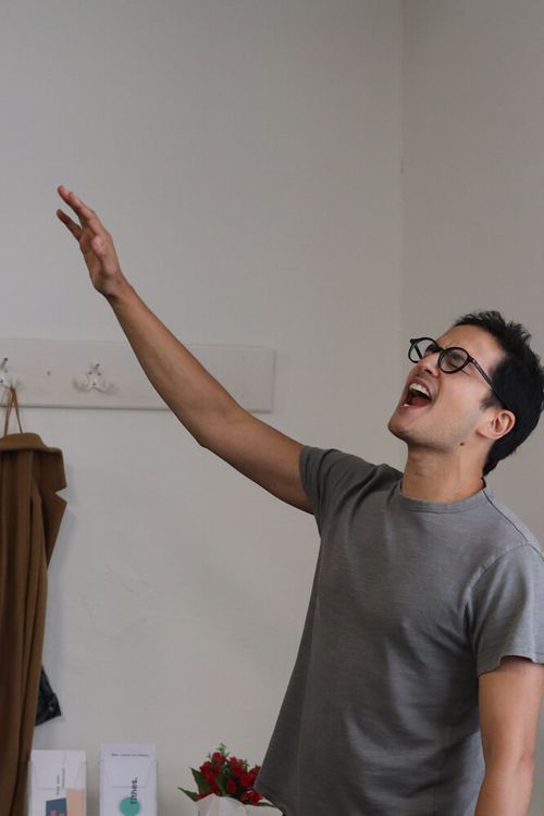 Man lifting hands in worship at The Lighthouse Centre in Brussels