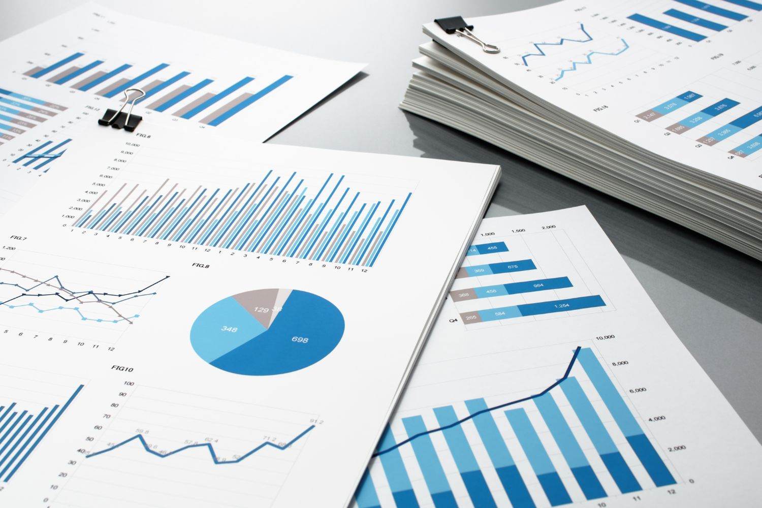 Image of multiple papers with reporting information