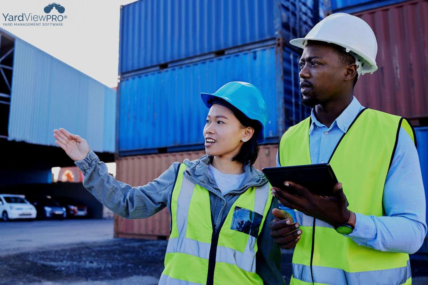 Image of a man and woman talking about the yard inventory while using a YMS on a tablet