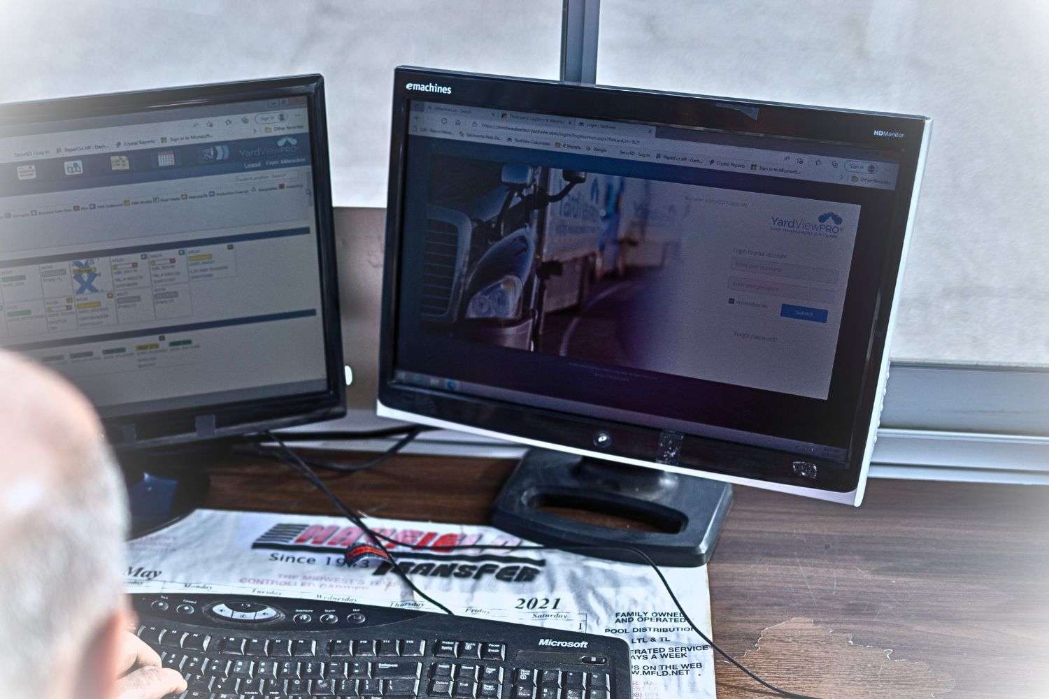 Image of a man using YardView YMS software on a desktop
