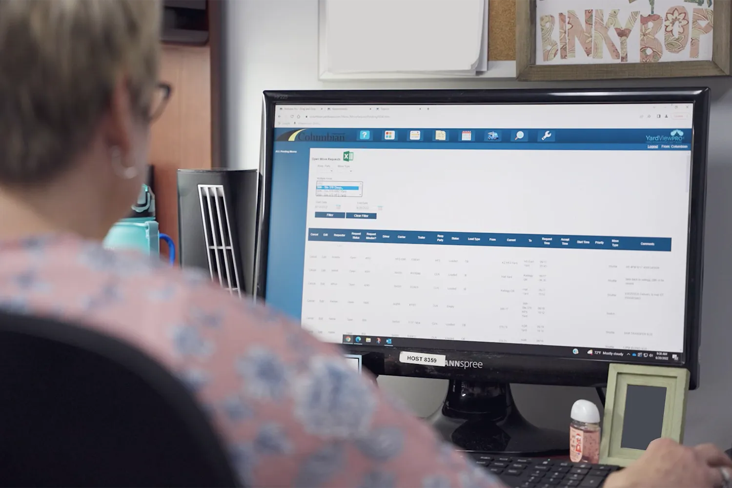 A woman looking at a report in the YardView YMS.