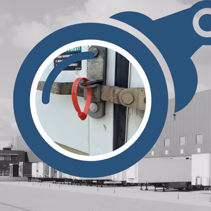 A zoomed in view of a seal on a trailer through one side of blue binoculars with a grey scale row of trucks at a dock in the background.