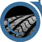 A close-up view of a tire through the left lens of "YardView" blue binoculars.