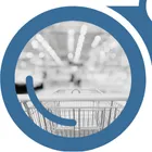 A close-up view of a retail cart entering a store seen through the left side of "YardView" blue binoculars.