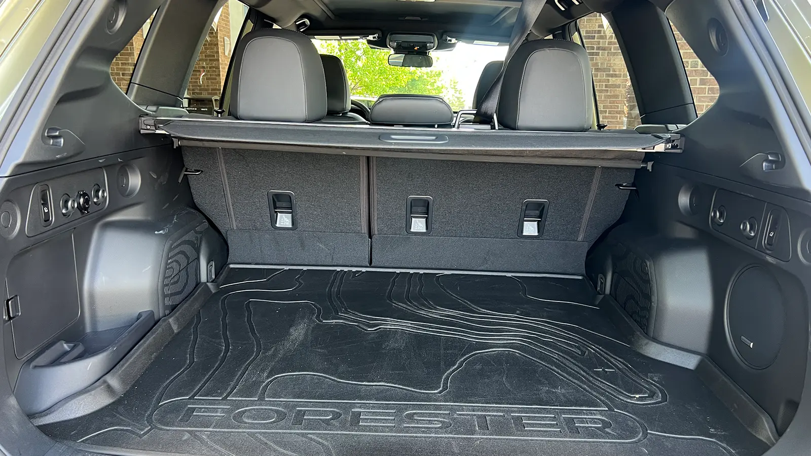 A green 2025 Subaru Forester Hybrid Review cargo view