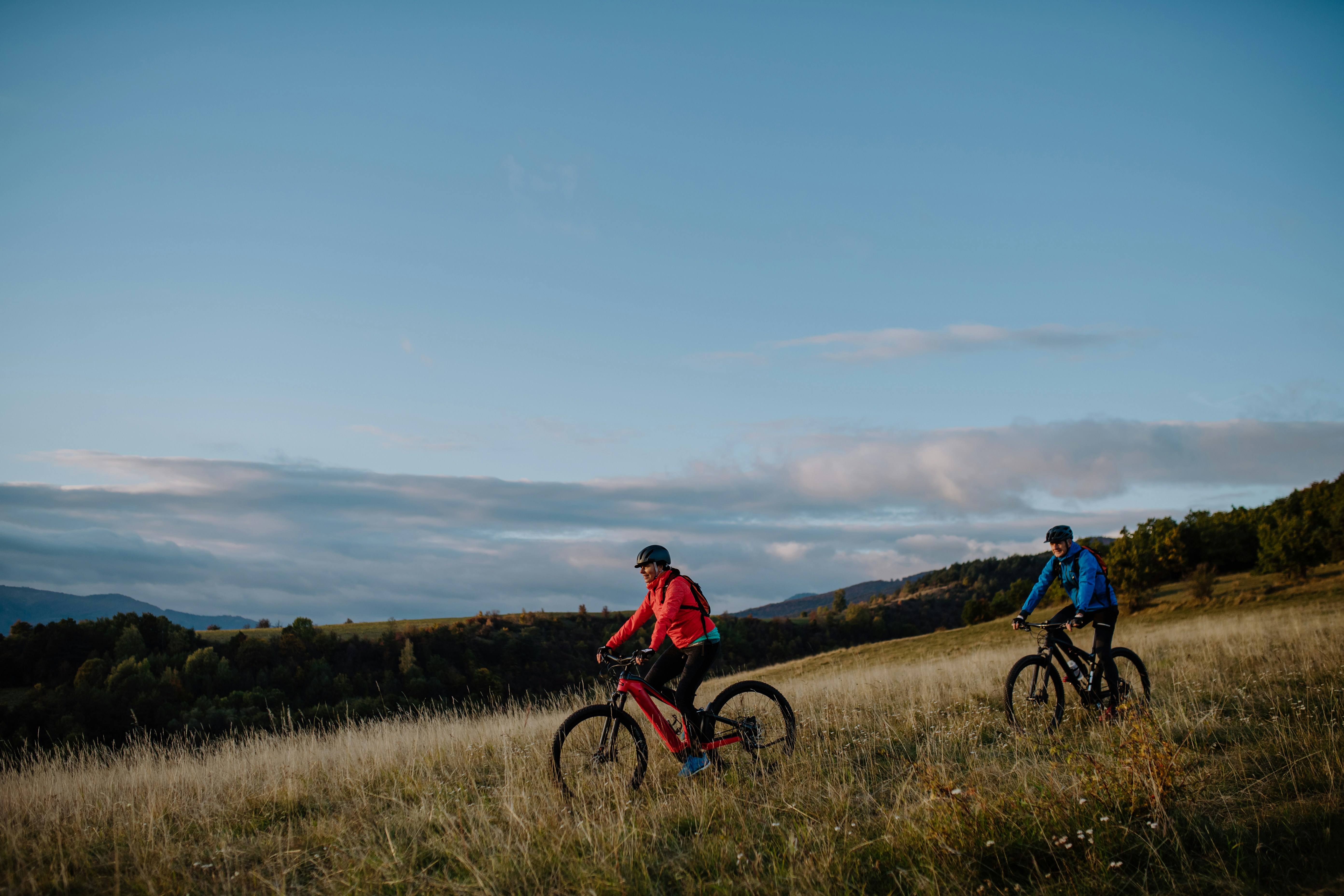 A couple riding an e-Bike in nature