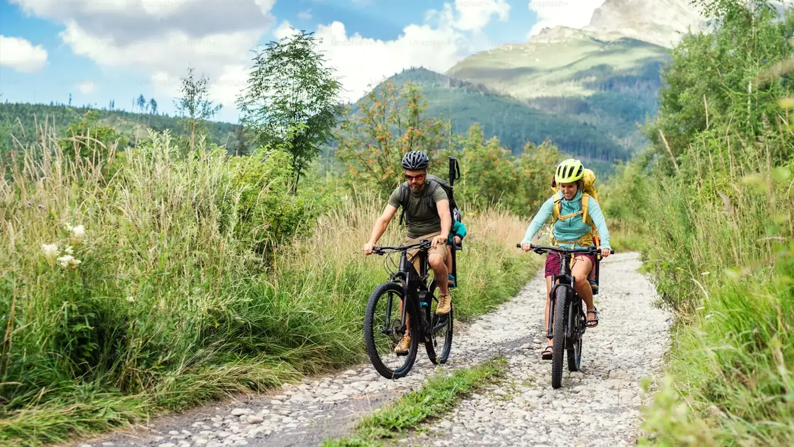 A couple riding a bike in the mountians