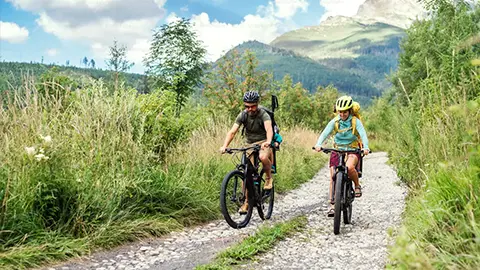 A couple riding a bike in the mountians