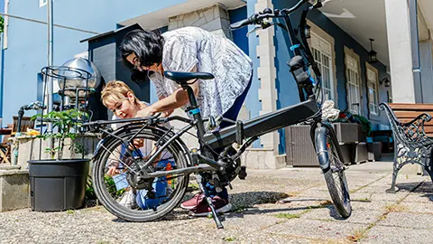A family inspecting an e-bike