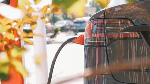 vehículo eléctrico estacionado y enchufado a un cargador eléctrico público