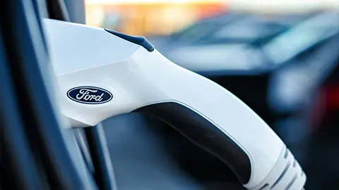 A Ford EV charger plugged into a vehicle