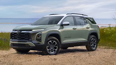 A green 2025 Chevrolet Equinox on the beach