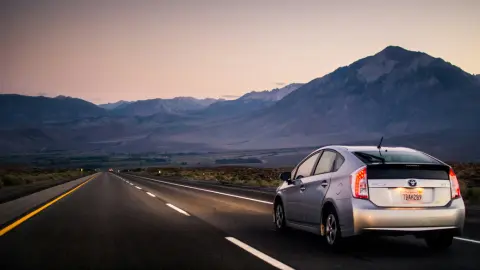 Toyota Prius driving down an open road