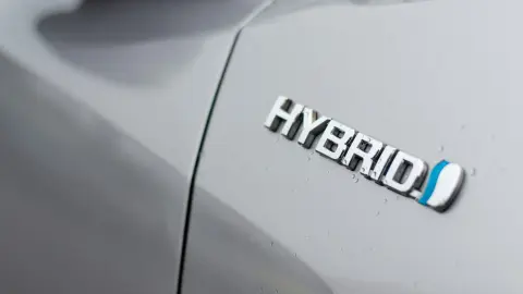 Hybrid vehicle logo on a silver hybrid car