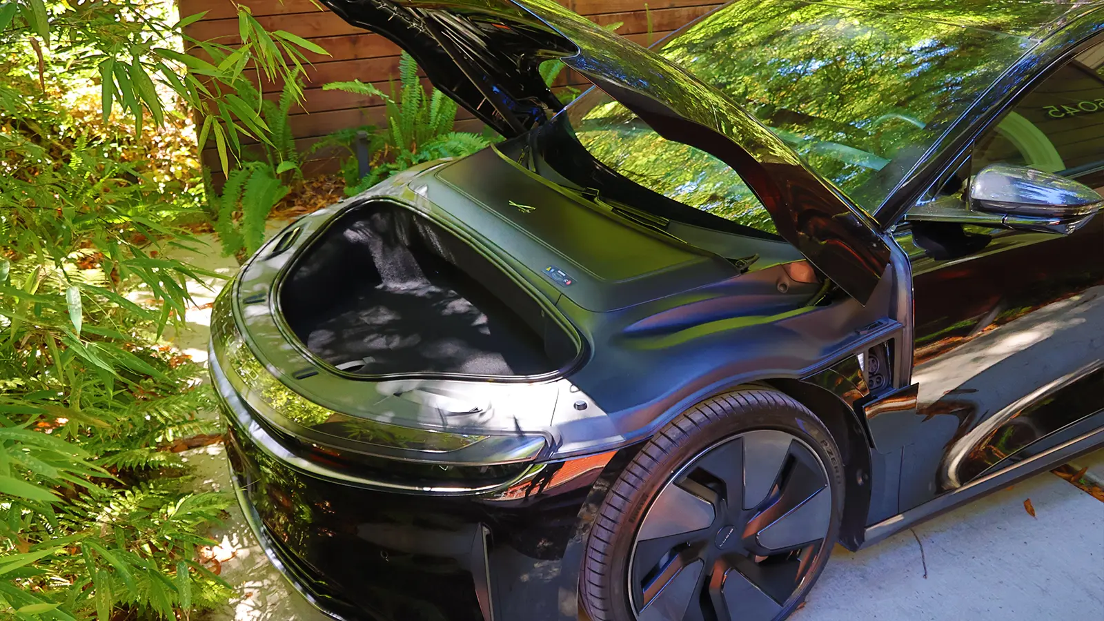 A Black 2025 Lucid Air Grand Touring in a beautiful scenic background front cargo bay