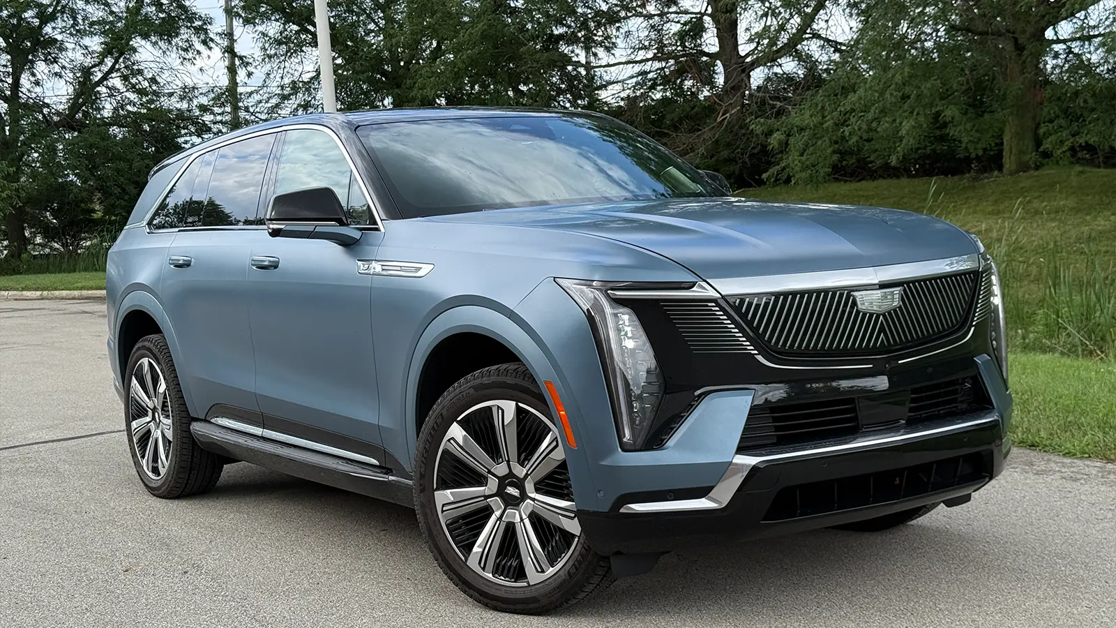 A light blue 2025 Cadillac Escalade IQ 