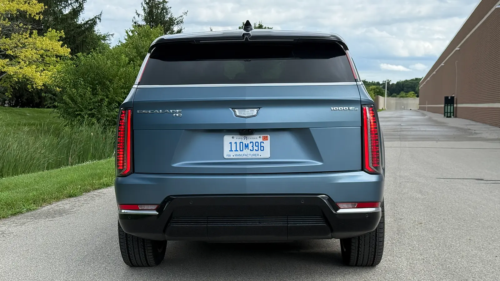 A light blue 2025 Cadillac Escalade IQ rear view