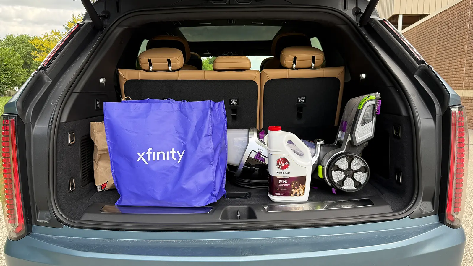 A light blue 2025 Cadillac Escalade IQ cargo bay
