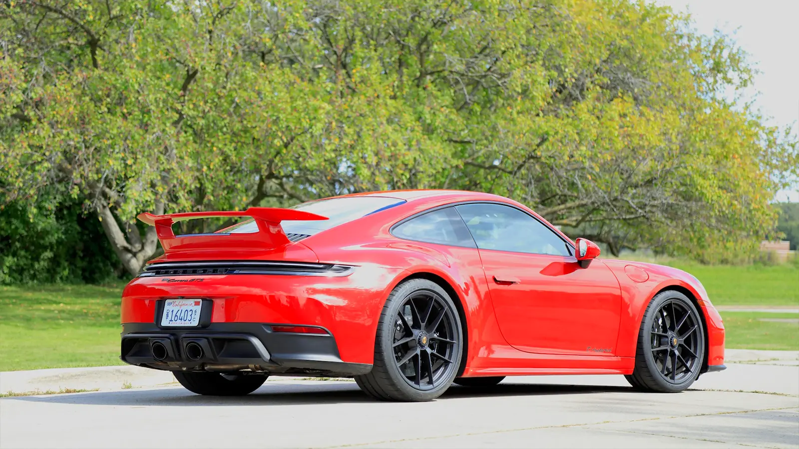 A red 2025 Porsche 911 Carrera GTS Hybrid