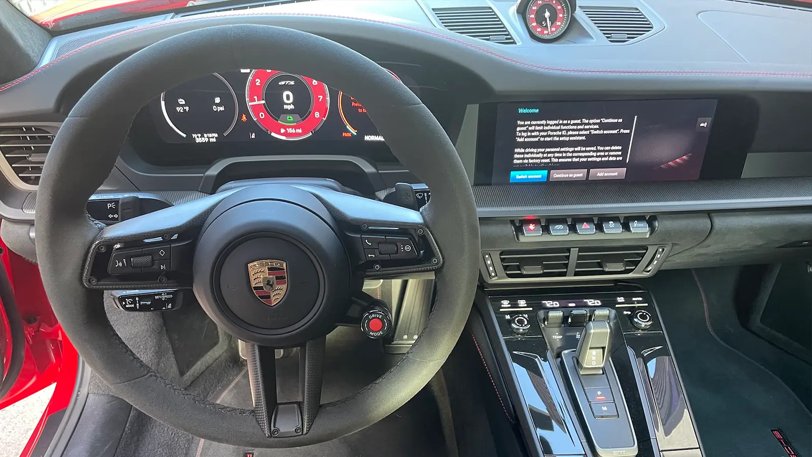 A red 2025 Porsche 911 Carrera GTS Hybrid drivers view