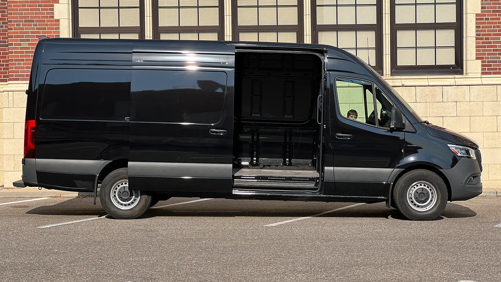 A black Mercedes eSprinter Cargo van side view