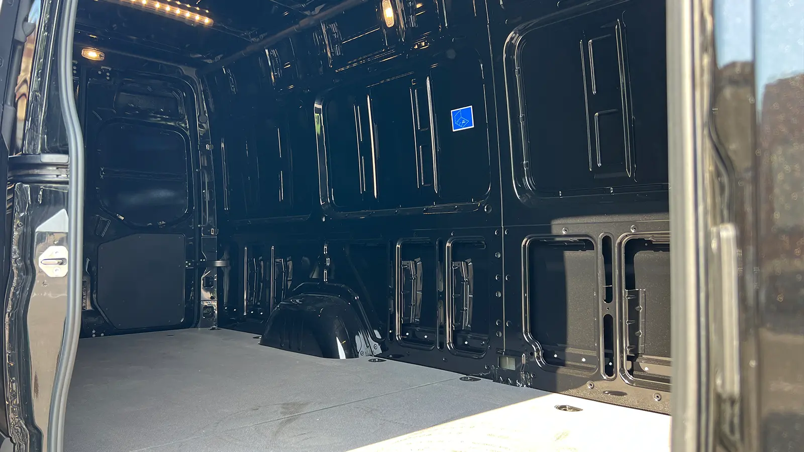 A black Mercedes eSprinter Cargo van cargo bay