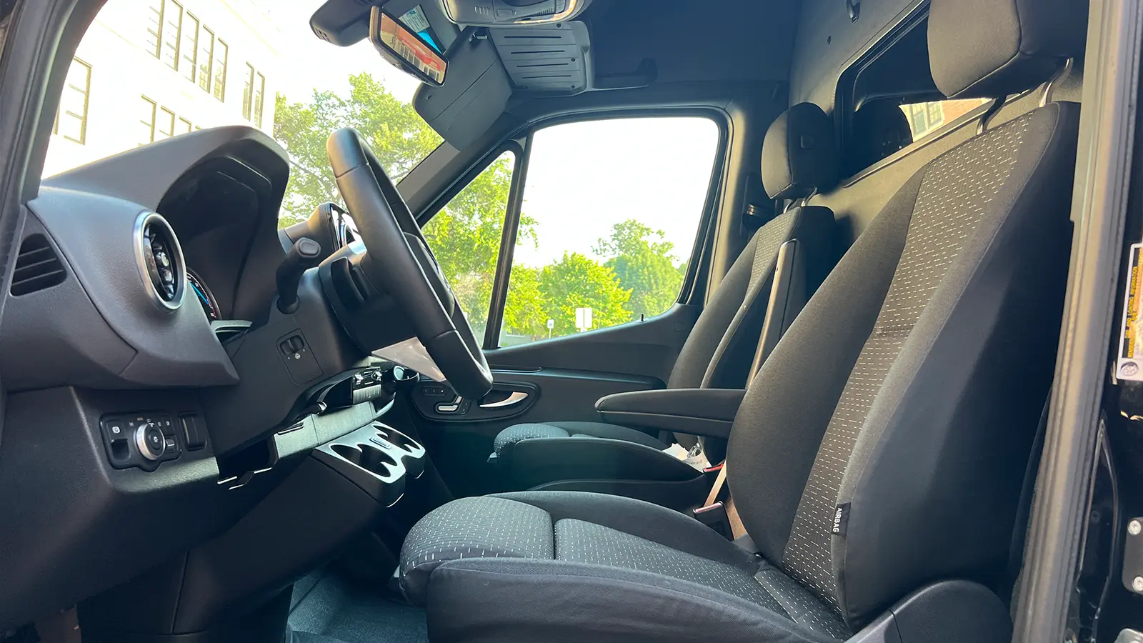A black Mercedes eSprinter Cargo van drivers view