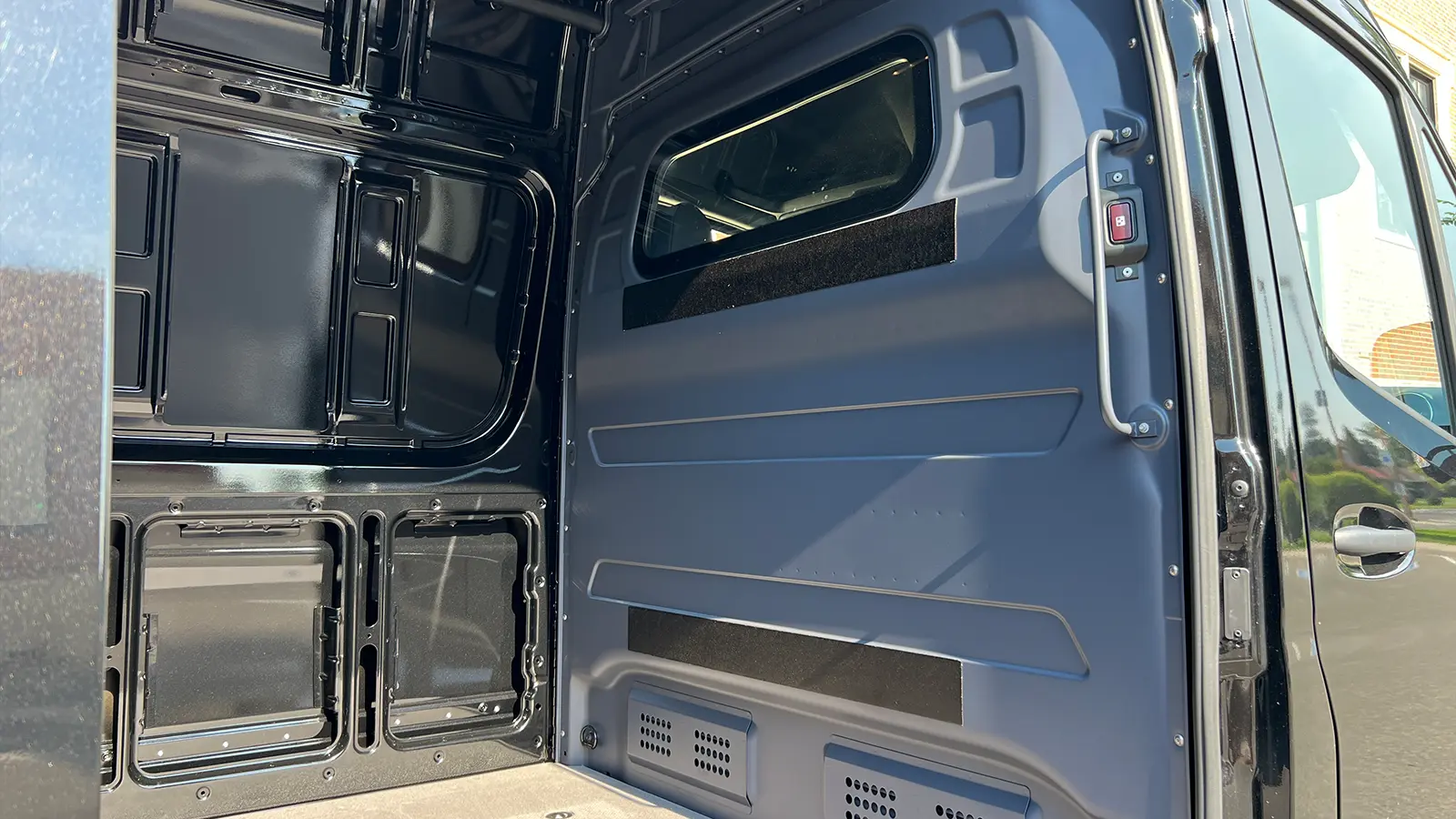 A black Mercedes eSprinter Cargo van 3 cargo side door