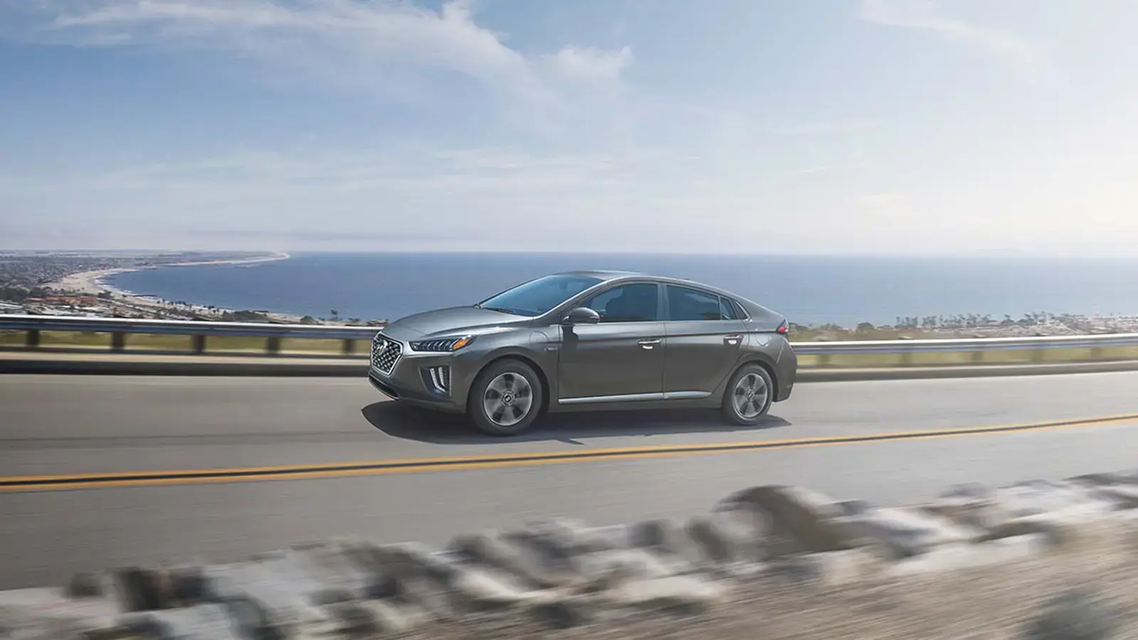 Plug-in Hybrid car driving down road