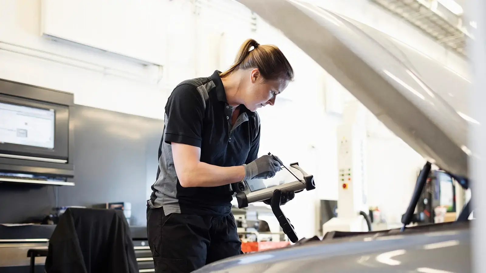 A women servicing a plug-in hybrid electric vehicle