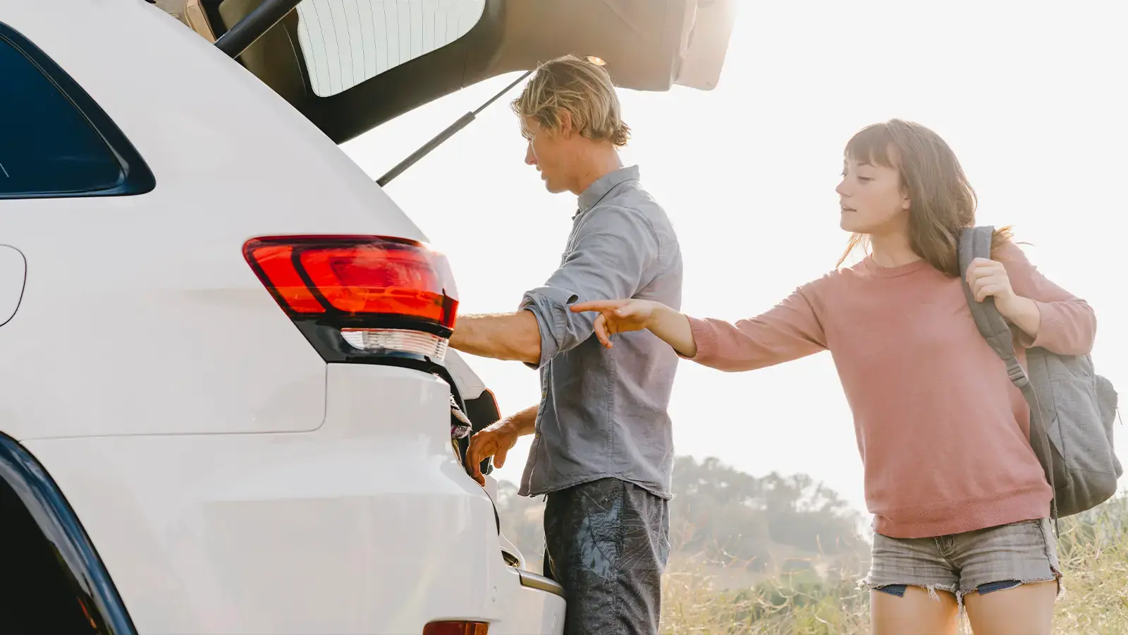 A happy couple unloading a EV