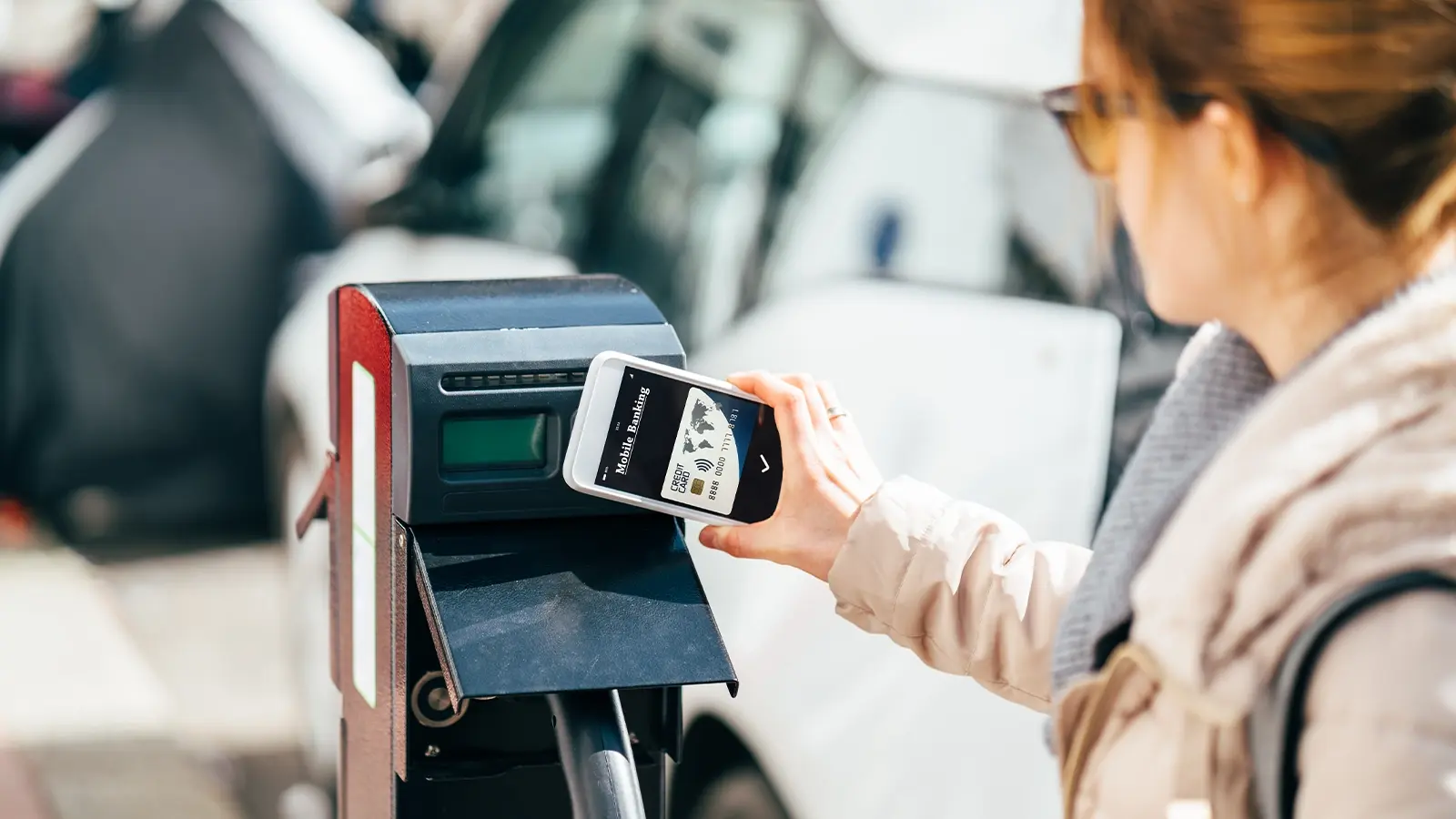 Lady scanning payment for EV charging