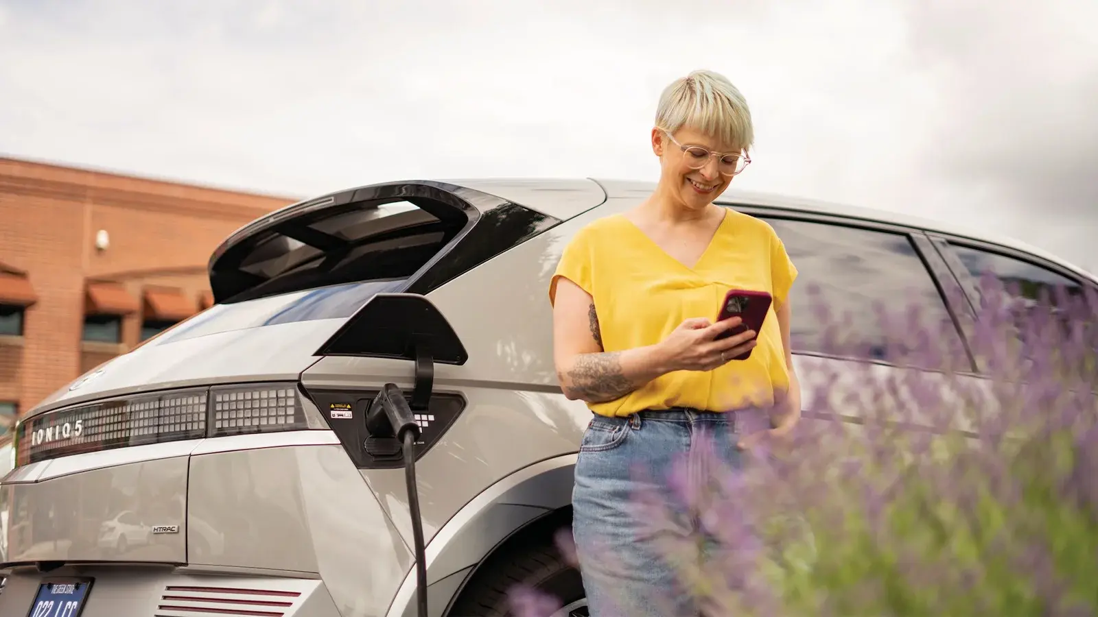 Person standing next to an EV 