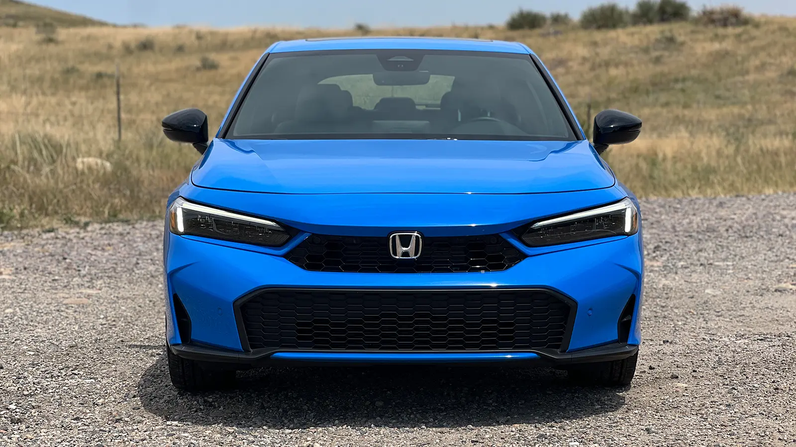 A blue 2025 Honda Civic Hatchback front view