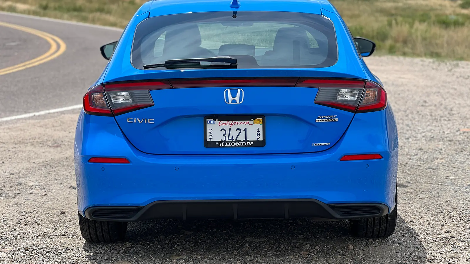 A blue 2025 Honda Civic Hatchback rear view