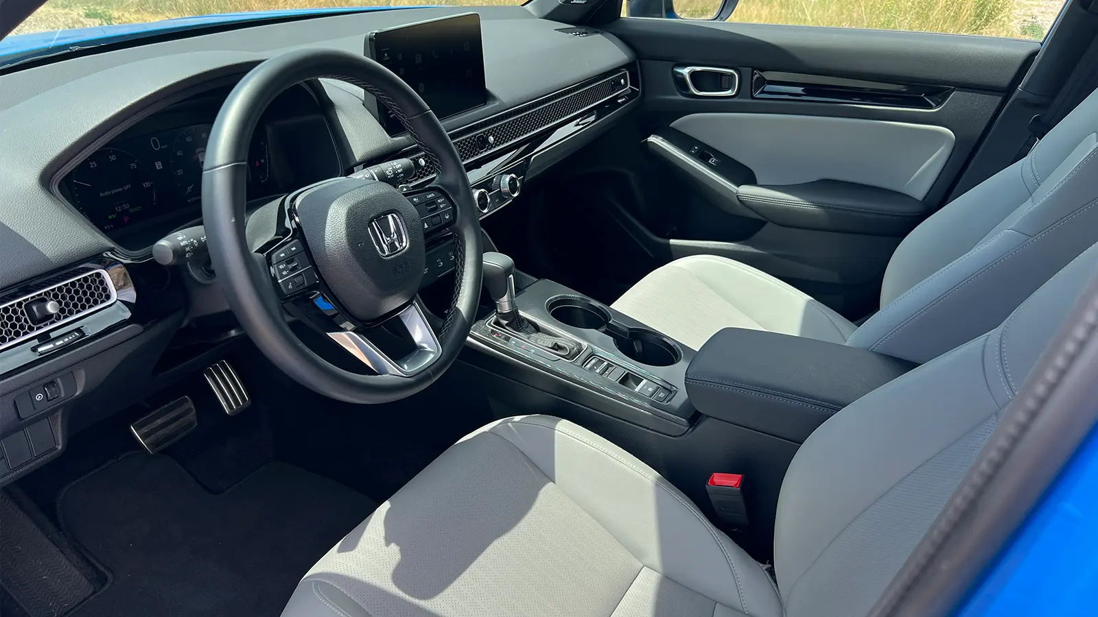 A blue 2025 Honda Civic Hatchback drivers interior view