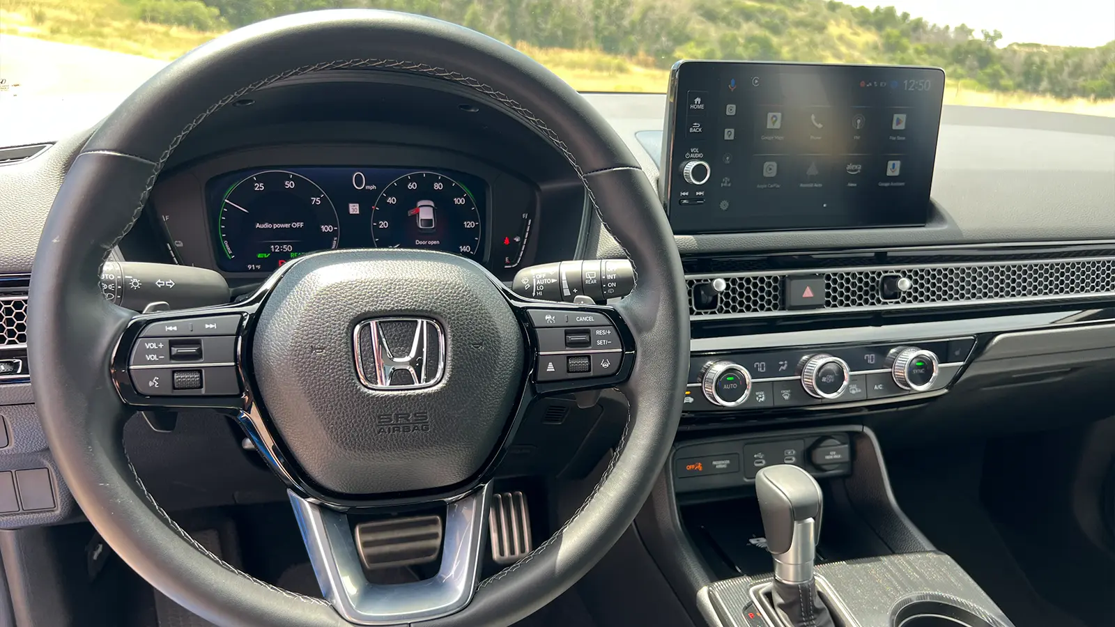 A blue 2025 Honda Civic Hatchback drivers HUD view