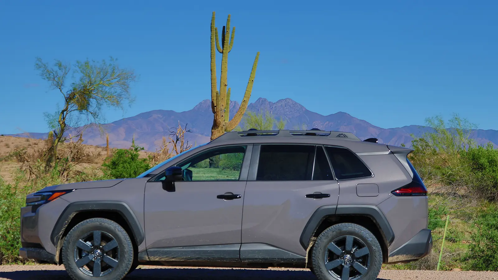 A gray 2026 Toyota Rav4 hybrid side view in the desert
