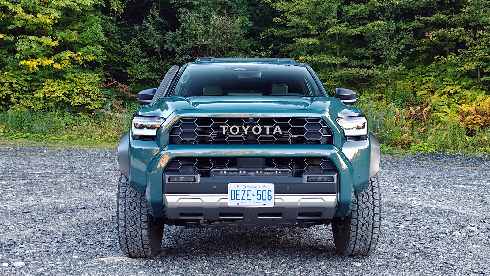 A blue 2025 Toyota 4Runner Trailhunter front view in the forest