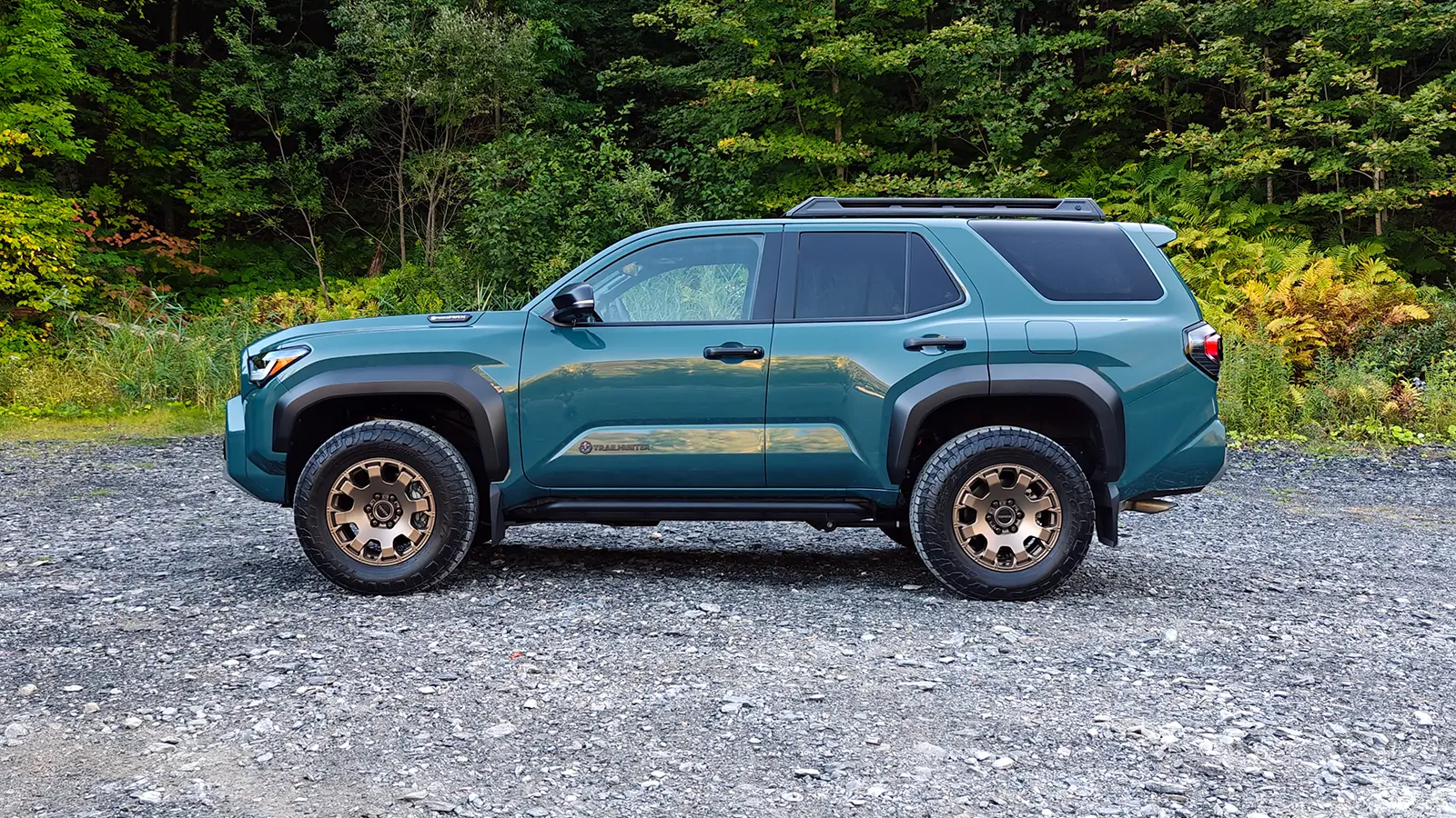 A blue 2025 Toyota 4Runner Trailhunter side view in the forest