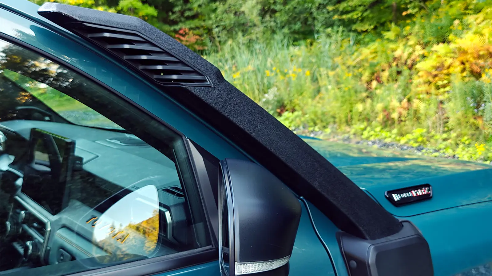 A blue 2025 Toyota 4Runner Trailhunter scuba view in the forest