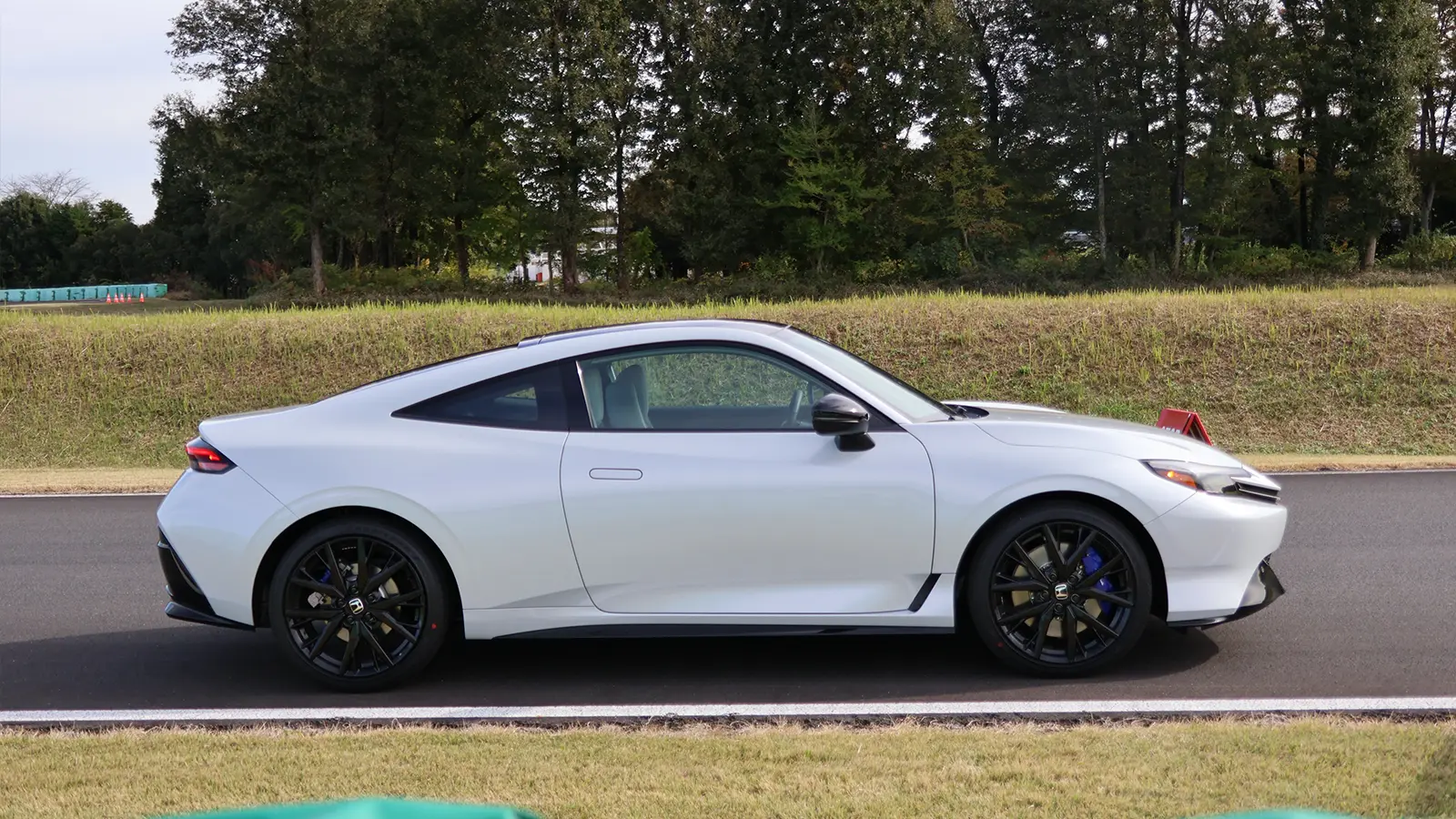 A white 2026 Honda Prelude on the track side profile