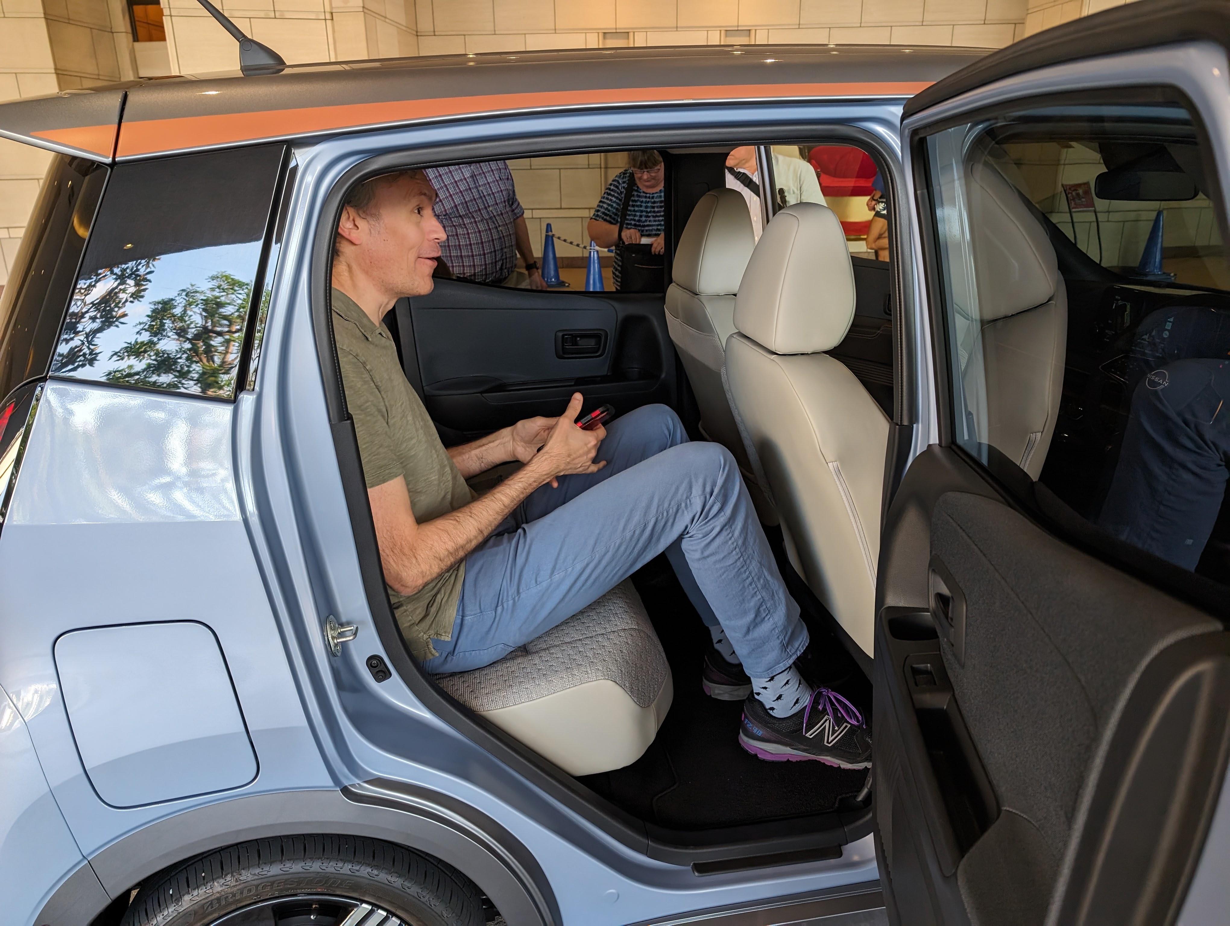 A light blue Nissan Sekura with door open
