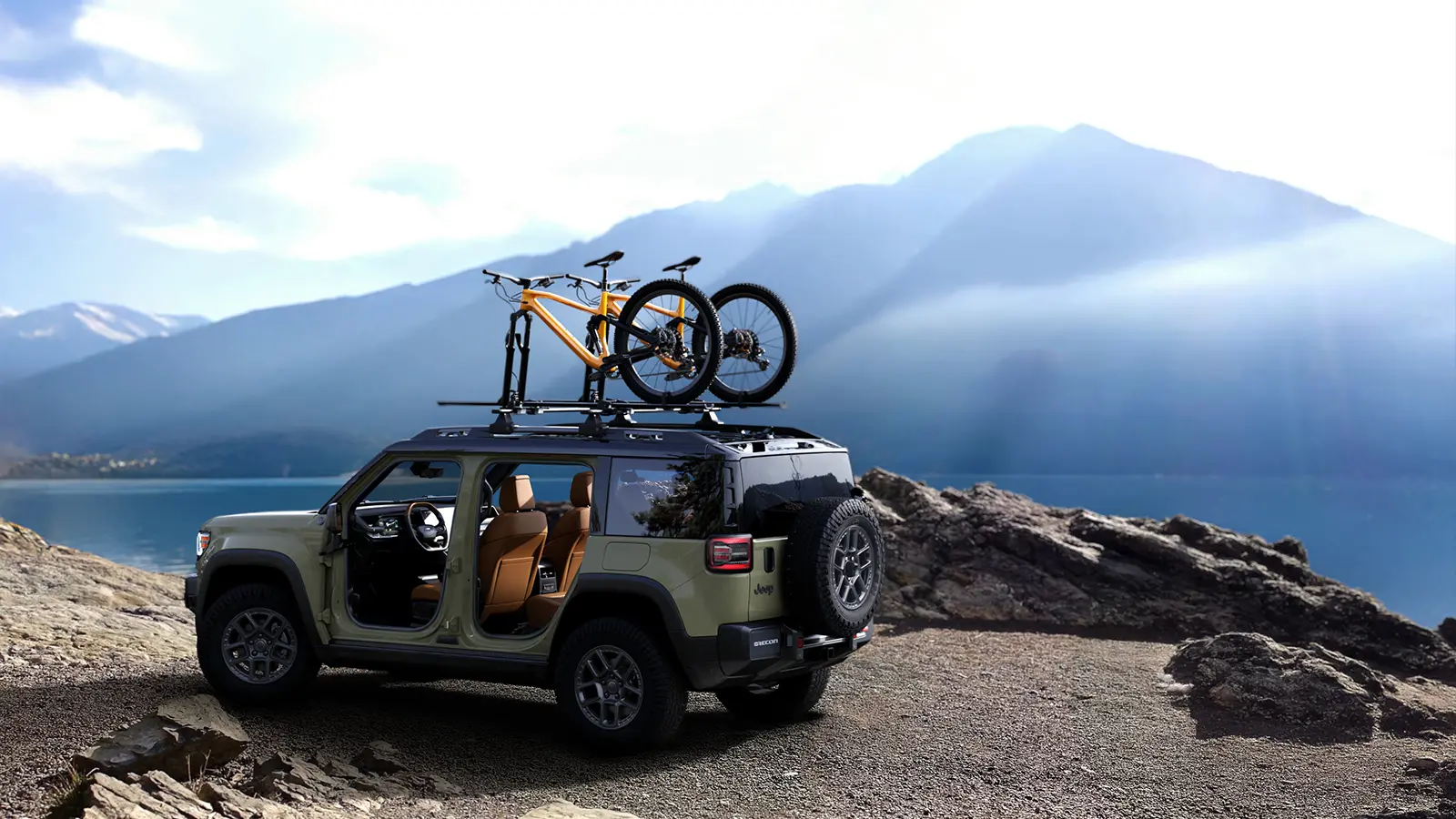 A tan 2026 Jeep Recon EV parked near a mountain lake