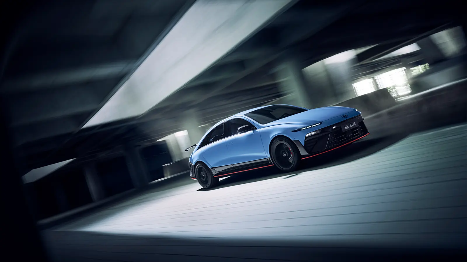 A blue 2026 Hyundai Ioniq 6 N in a parking garage tarck