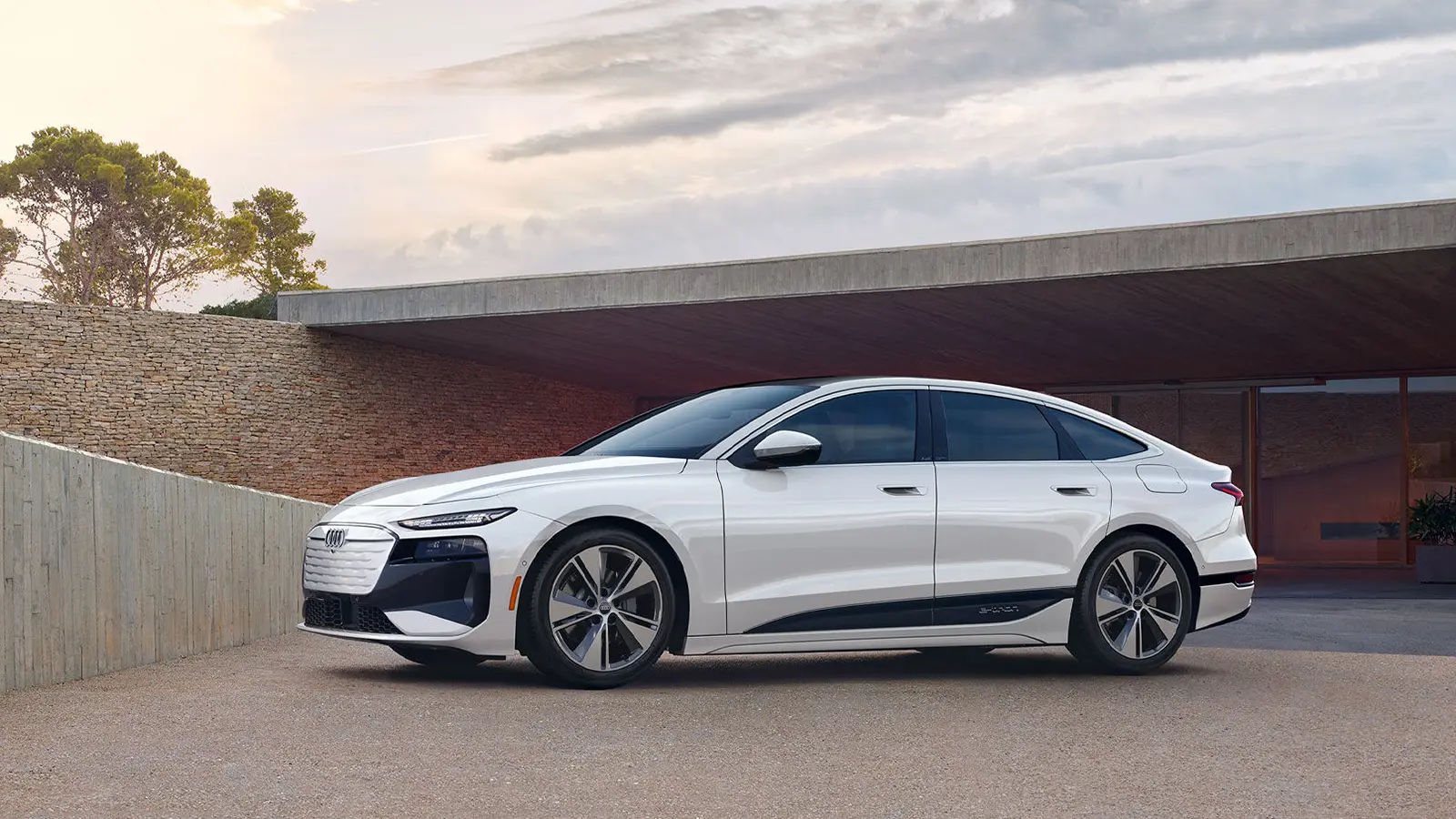 A white 2025 Audi A6 e-Tron Sportback in a driveway
