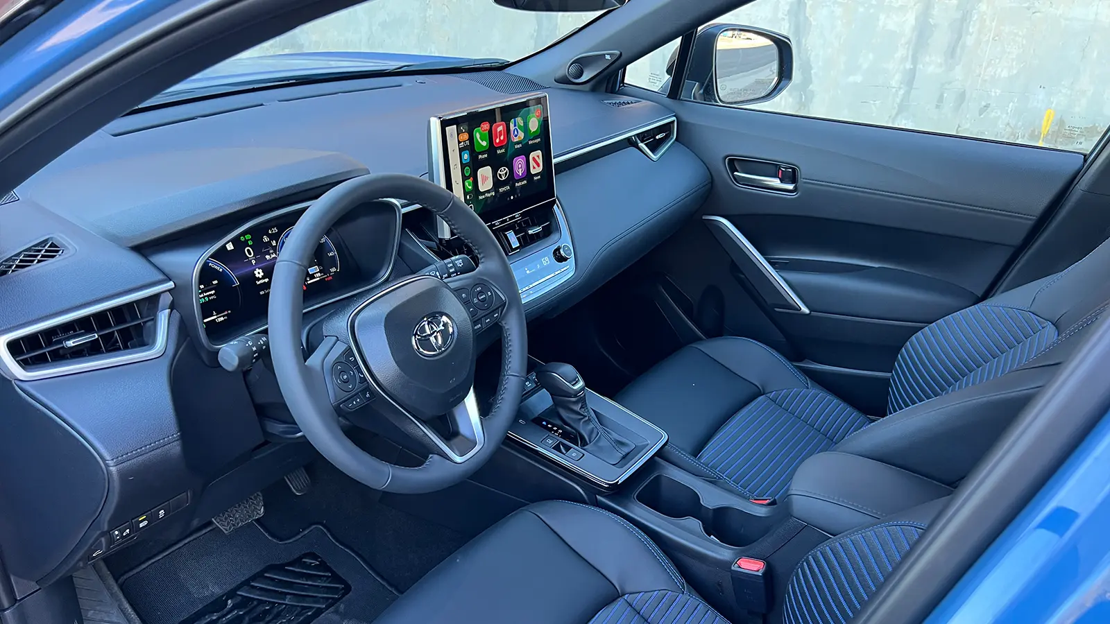 A blue 2026 Toyota Corolla Cross hybrid front HUD view