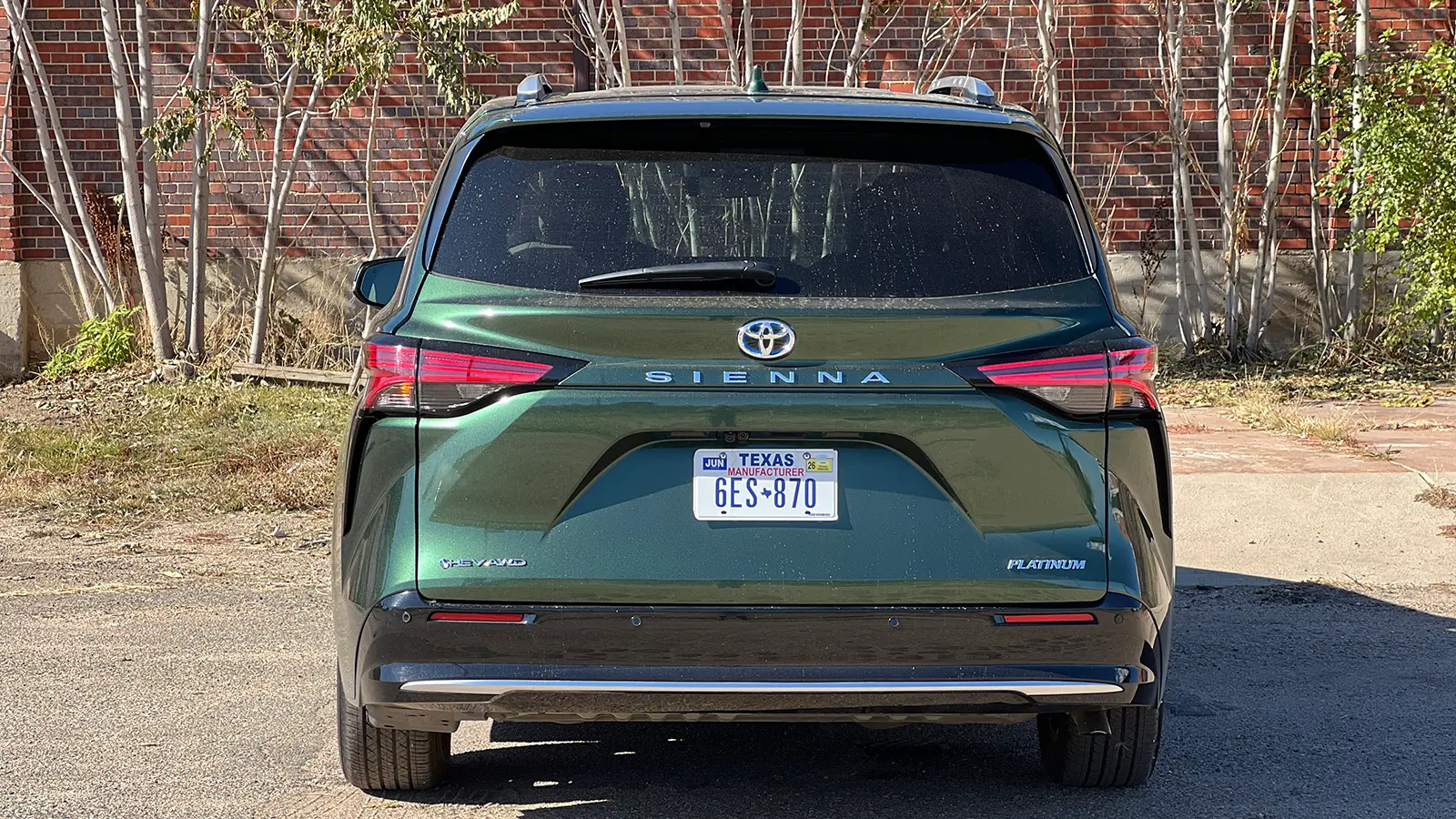 A green 2025 Toyota Sienna Hybrid Platinum AWD rear view