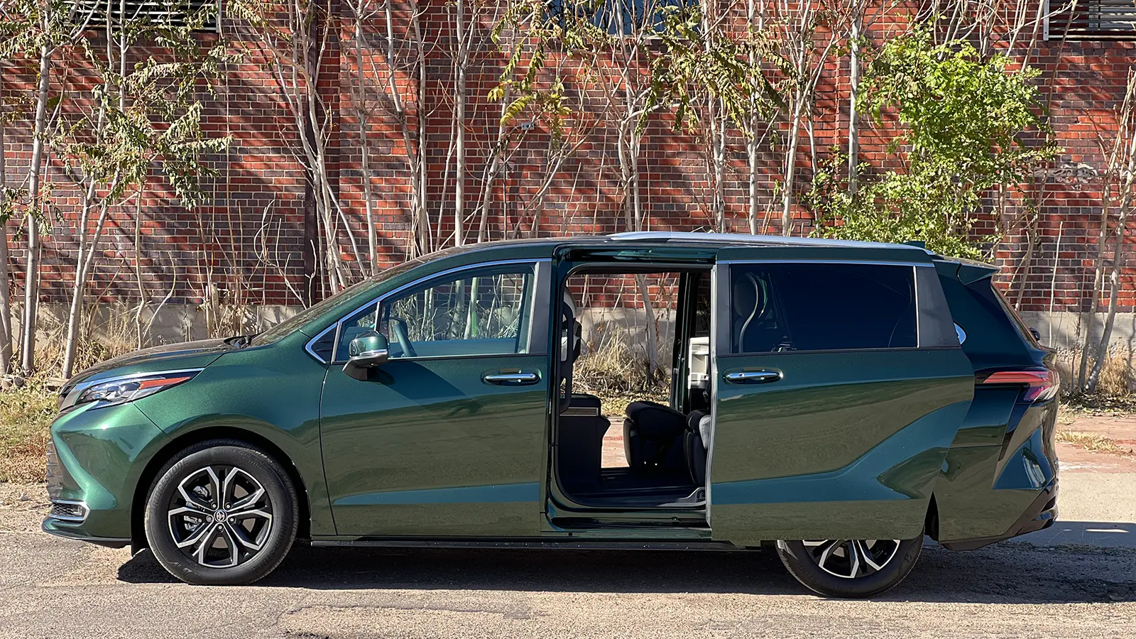 A green 2025 Toyota Sienna Hybrid Platinum AWD side view with door open