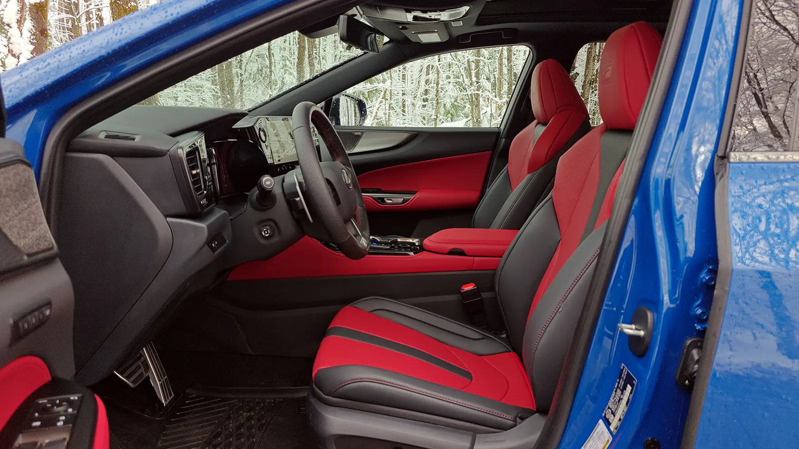 A blue 2026 Lexus NX 350h F Sport side driver view